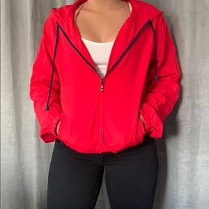 Bright red, zip up wind breaker